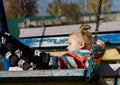 Little sad girl on a swing in the park. Royalty Free Stock Photo