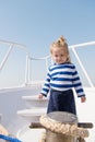 Little sailor kid on boat. funny kid in striped marine shirt. traveling adventures and wanderlust. summer vacation Royalty Free Stock Photo