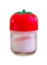 Little saltshaker with a tomato top full with salt on a white background