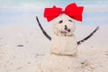 Little sandy snowman with bow on white Caribbean Royalty Free Stock Photo