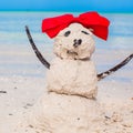 Little sandy snowman with bow on white Caribbean Royalty Free Stock Photo