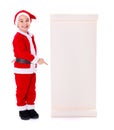Little Santa Claus boy pointing at big wishlist