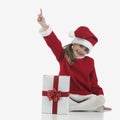 A little santa claus girl that indicates Royalty Free Stock Photo