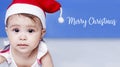 Little Santa. 1-year-old baby girl in Santa Claus hat. Merry Christmas. Adorable middle-eastern girl in Santa cap