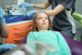 Little scared girl sitting in chair in dentist doctor office. Kid,child afraid of tooth extraction, teeth treatment