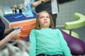 Little scared girl sitting in chair in dentist doctor office. Kid,child afraid of tooth extraction, teeth treatment