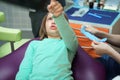 Little scared girl sitting in chair in dentist doctor office. Kid,child afraid of tooth extraction, teeth treatment