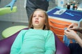 Little scared girl sitting in chair in dentist doctor office. Kid,child afraid of tooth extraction, teeth treatment