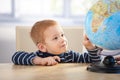 Little scholar studying globe smiling Royalty Free Stock Photo