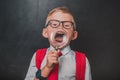 Little school boy express positive and negative emotions through a magnifying glass. Go back to school. Educat how to Royalty Free Stock Photo