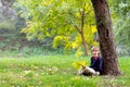 Little school boy under colorful autumn tree Royalty Free Stock Photo