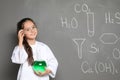 Little school child in laboratory uniform with flask Royalty Free Stock Photo