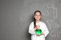 Little school child in laboratory uniform with flask Royalty Free Stock Photo