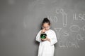 Little school child in laboratory uniform with flask Royalty Free Stock Photo