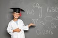 Little school child in laboratory uniform with graduate cap Royalty Free Stock Photo