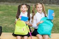 Little school friends girls with backpacks, sincere happiness concept Royalty Free Stock Photo