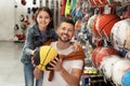 Little school girl with father choosing ball