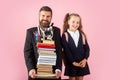 Little school girl and fether teacher with hold a books with school bag is back to school, empty space in studio Royalty Free Stock Photo