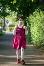 Little school girl going back to school after pandemic outbreak wearing an face mask Royalty Free Stock Photo