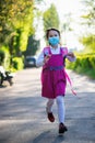 Little school girl going back to school after pandemic outbreak wearing an face mask Royalty Free Stock Photo