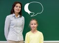Little school girl with teacher at blackboard Royalty Free Stock Photo