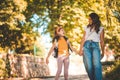 Little school girl walking with mom in nature Royalty Free Stock Photo