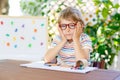 Little school kid boy with glasses holding wax crayons Royalty Free Stock Photo