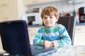 Little school kid boy playing game and surfing internet on computer. Child having fun with learning on pc. Education Royalty Free Stock Photo