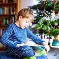 Little school kid boy reading a book on Christmas Royalty Free Stock Photo