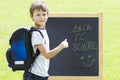 Little schoolboy against the blackboard. Education, Back to school concept