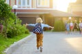 Little schoolboy joyfully running to school after holiday. Child meeting with friends. Education for children. Back to school Royalty Free Stock Photo