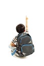 Little schoolboy with schoolbag pointing at empty copy space