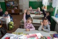 Little schoolchildren raise their hands in the classroom,3.11. 2014 Ukraine Mervichi