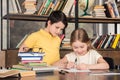 Little schoolchildren studying in library together Royalty Free Stock Photo