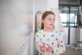 Little schoolgirl with down syndrome standing in front of whiteboard Royalty Free Stock Photo