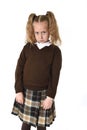 Little schoolgirl girl with beautiful blonde hair in school uniform looking shy and timid