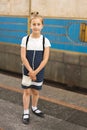 Little schoolgirl on the platform in the subway. vertical photo