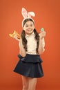 Little schoolgirl in rabbit ears hold carrot. Easter eggs. Happy easter. Origins of Easter Traditions. Small girl bunny Royalty Free Stock Photo