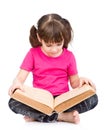 Little schoolgirl reading big book. isolated on white background Royalty Free Stock Photo