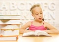Little schoolgirl reading a book. Royalty Free Stock Photo
