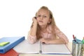 Little schoolgirl sad and tired looking depressed suffering stress overwhelmed by load of homework Royalty Free Stock Photo