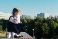 Little schoolgirl sits on a textbook and cries, does not want to study