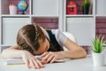 Little schoolgirl sleeps at her desk during a lesson Royalty Free Stock Photo