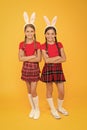 Little schoolgirls school uniform with long bunny ears. Easter traditional games. Bunny team. Entertainment and event Royalty Free Stock Photo