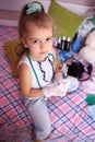 Little serious girl in a medicalg gloves with stethoscope at home playing doctor Royalty Free Stock Photo
