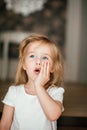 Little shaggy blonde baby girl with blue eyes is smiling after her morning awaking Royalty Free Stock Photo