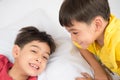 Little sibling boy lay on the pillow on the floor together