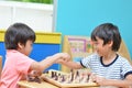 Little sibling boy playing chess