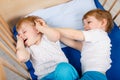 Little sibling boys having fun in bed at home Royalty Free Stock Photo