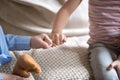 Little siblings reconciling after fight joining pinkies close up